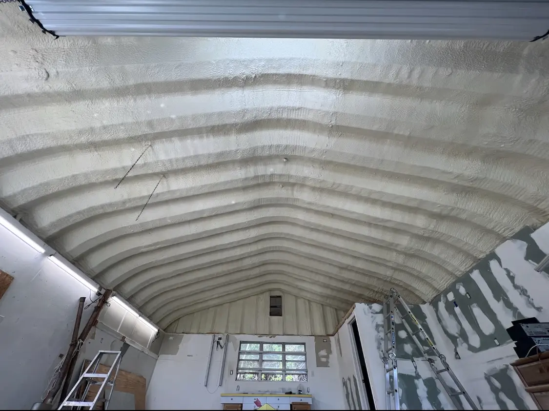 Spray polyurethane foam applied to the underside of a metal roof deck in Seguin